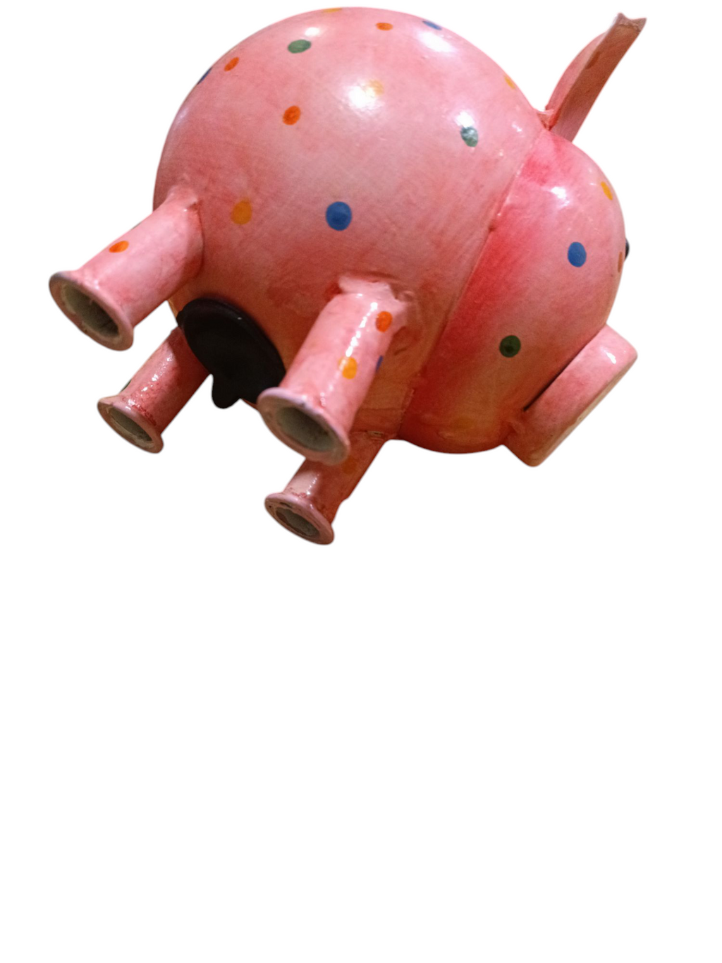 Objeto decorativo em forma de porco cor-de-rosa com manchas coloridas