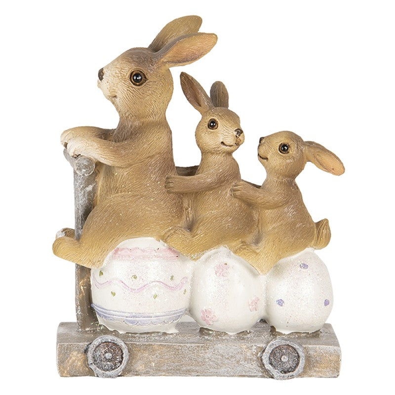 Escultura de coelhos e ovos num carrinho decorativo