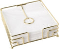 Suporte dourado para guardanapos com guardanapos brancos