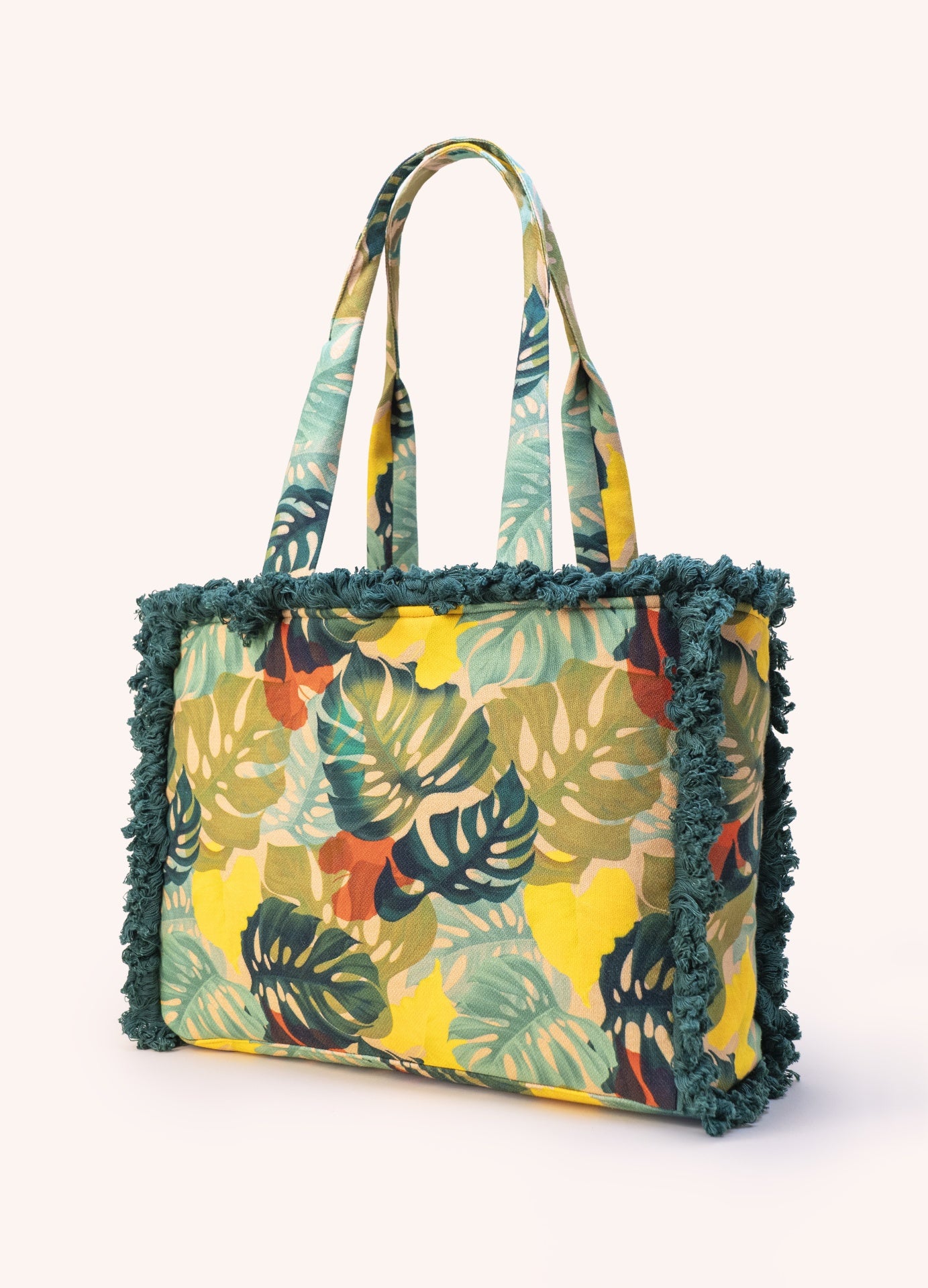 Saco tecido com padrão folhas tropicais e franjas verdes