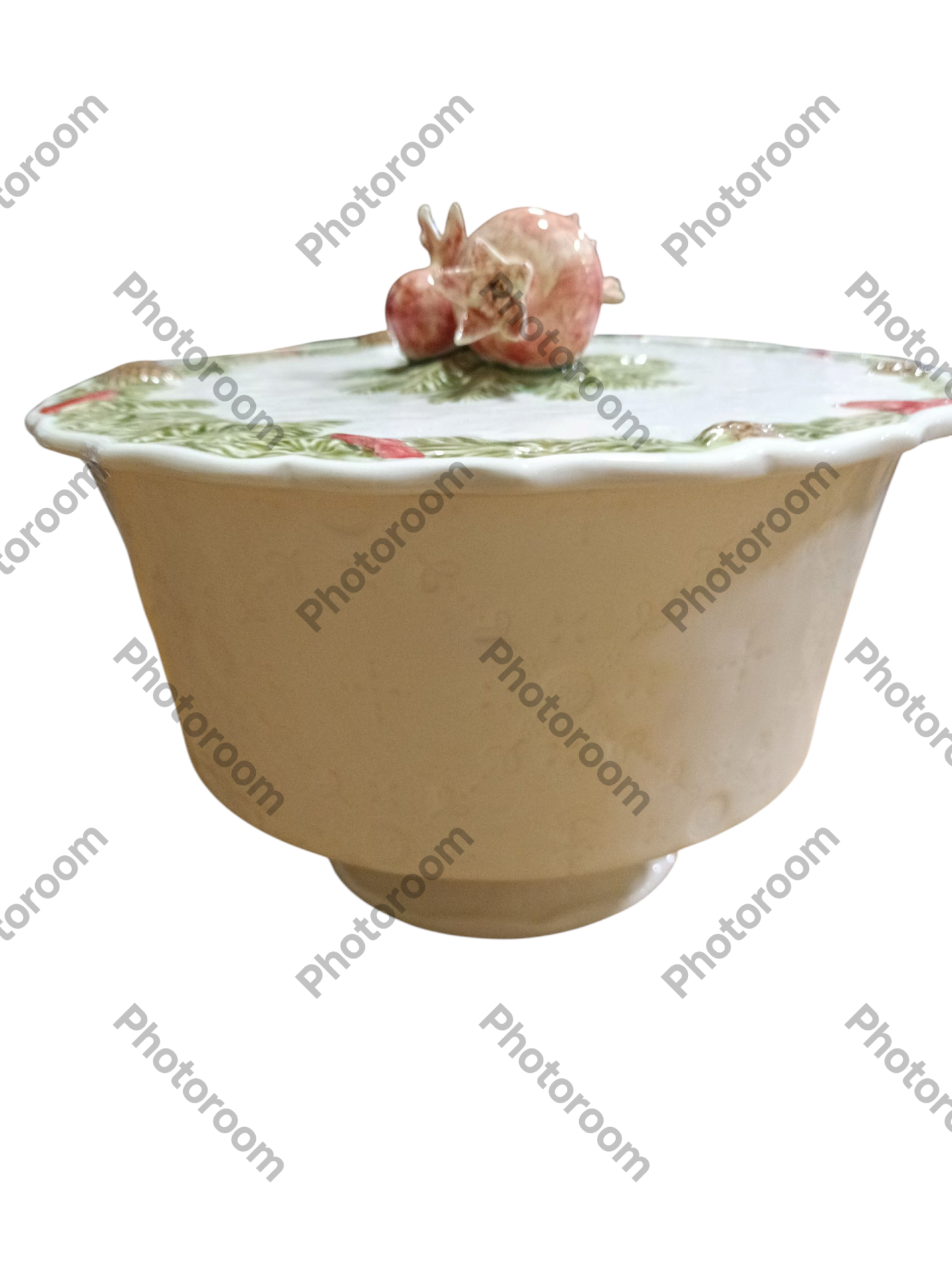 Recipiente de cerâmica creme com tampa decorativa com romãs coloridas em relevo.