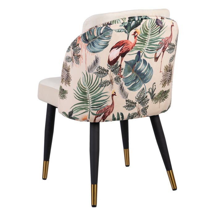 Cadeira estofada creme com encosto estampado de folhas e aves, pernas pretas com pontas douradas