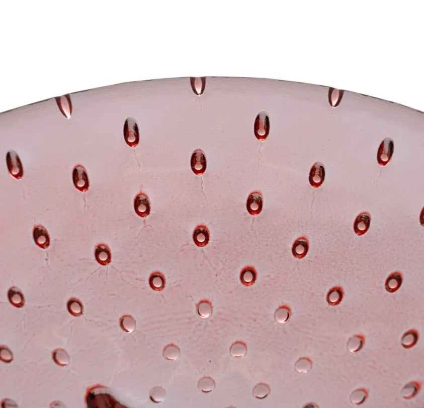 Superfície redonda cor-de-rosa com pontos em relevo