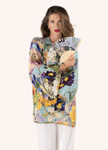 Mulher de camisa floral colorida e leque com padrão semelhante