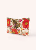 Mala de mão almofadada com padrão floral colorido num fundo creme
