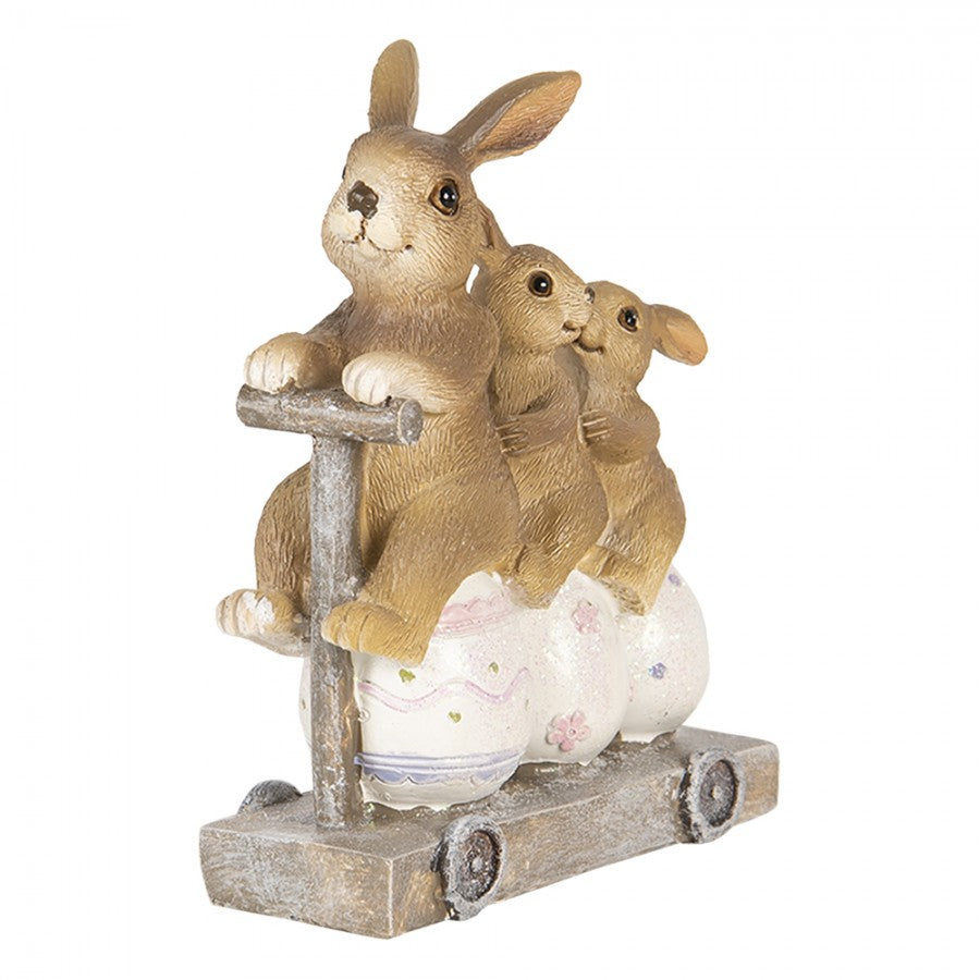 Figura decorativa de coelhos e ovos com base tipo carrinho