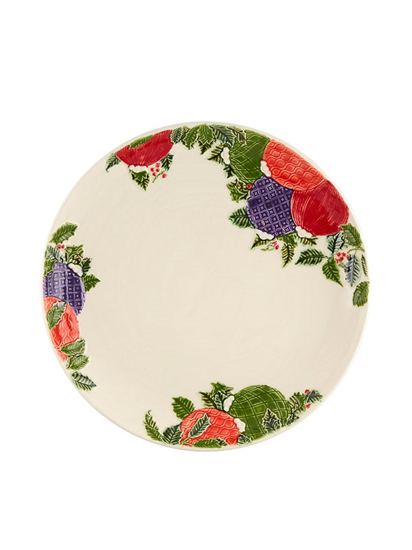 Prato decorado com folhas verdes e frutas coloridas nas bordas