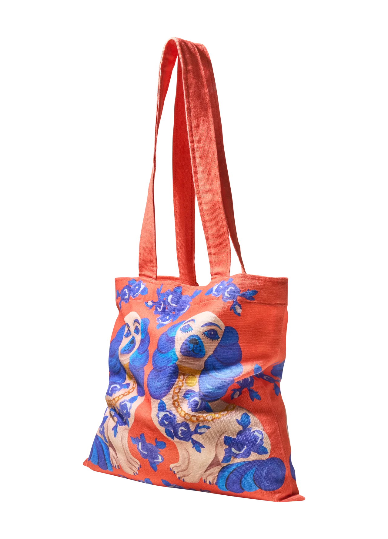 Saco de tecido laranja com estampa de cães e flores azuis.