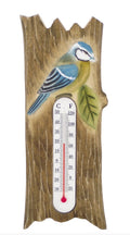 Termómetro decorativo com pássaro azul e imitação de madeira.